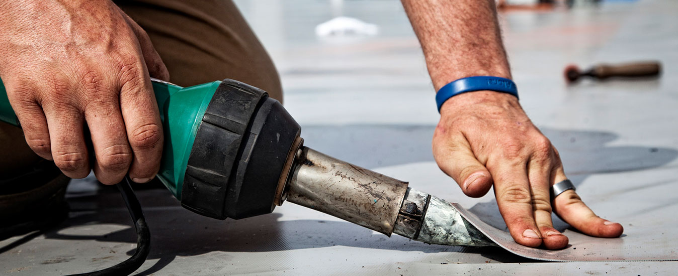  A&A Contracting Experienced Roofer repairs a commercial flat roof